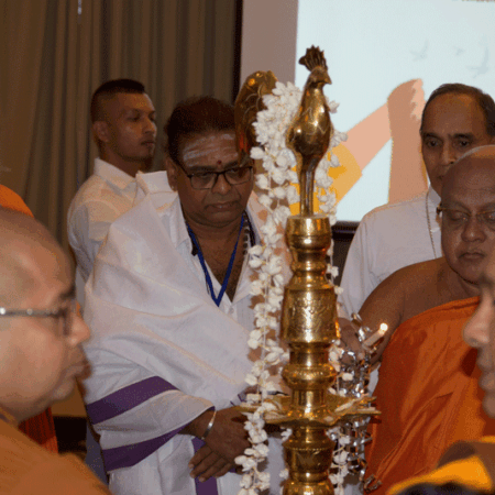 religious leaders light ceremonial lamp