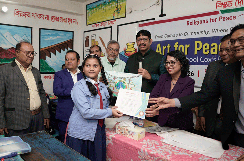 child receiving certificate for artwork