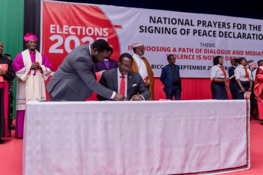 presidential candidate signing a pledge for peace in Malawi