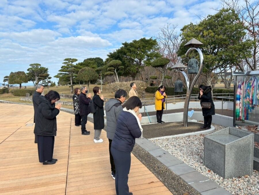 people praying at a monument